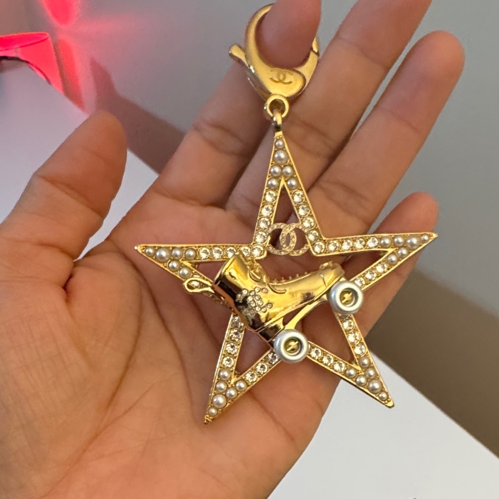CHANEL Gold Star Key Holder with Roller Skate